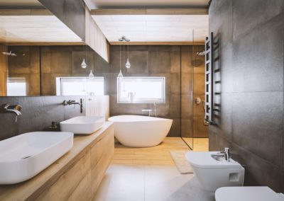 Stylish bathroom with double sinks, toilet, bidet & bath